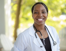 Sheveen Greene-Adenaike in a white lab coat